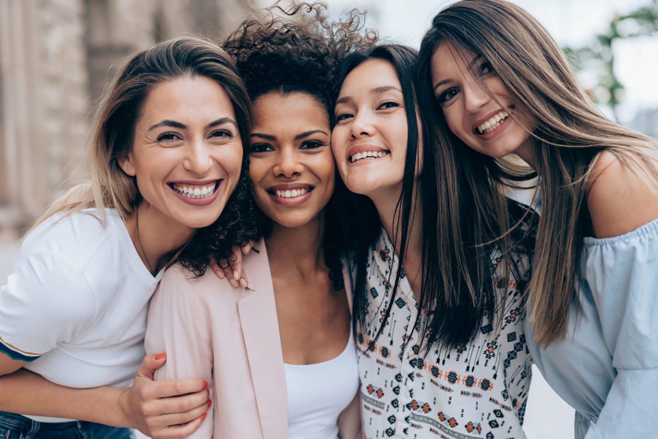four young, smiling women